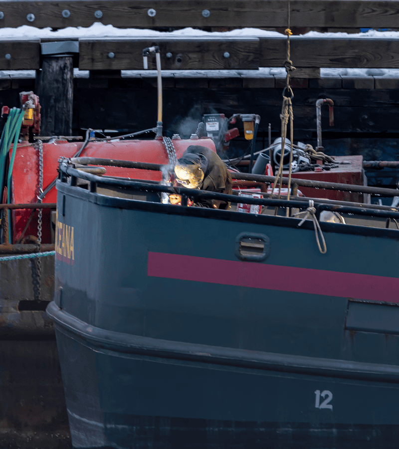 Welder working on a boat deck