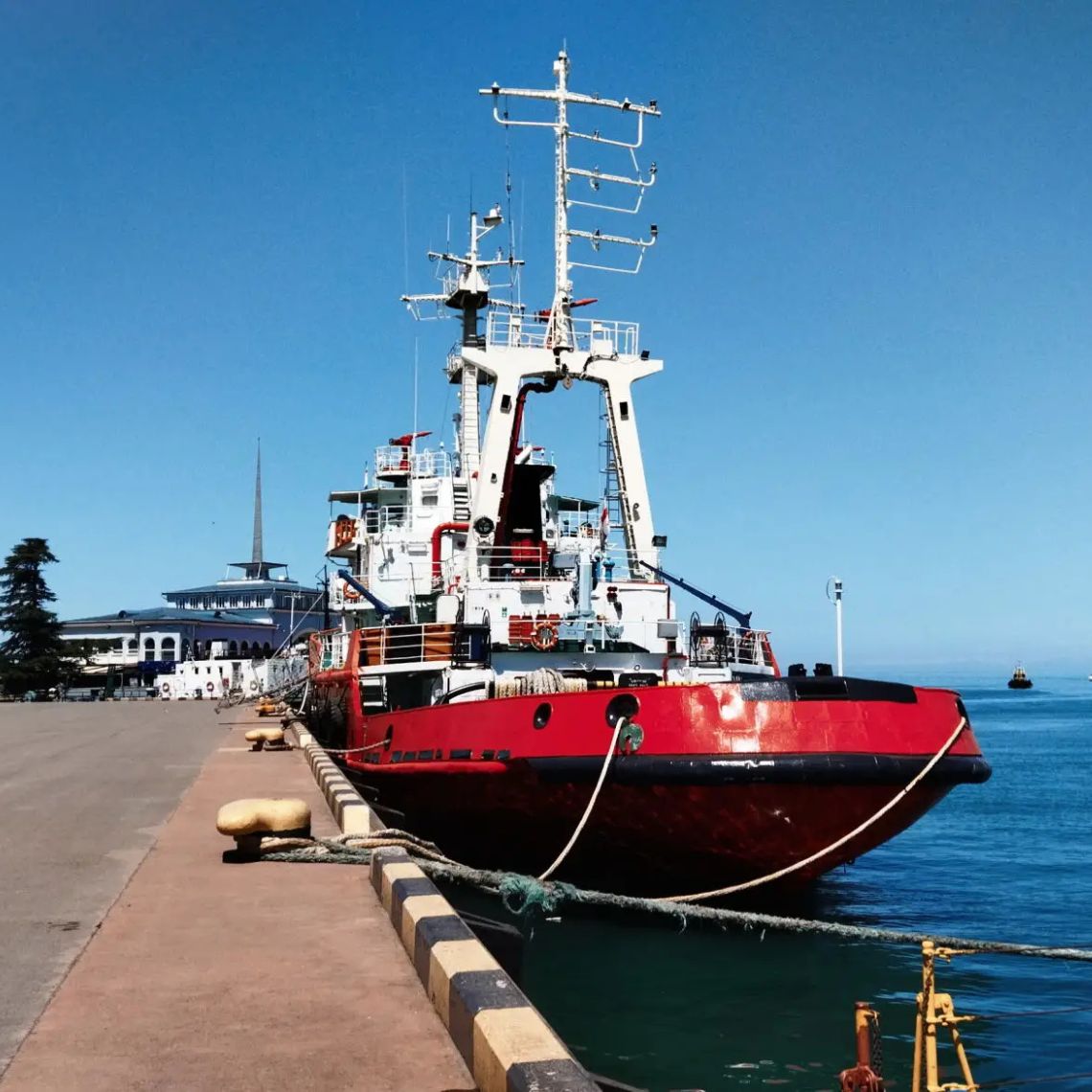 Red ship docked at harbor