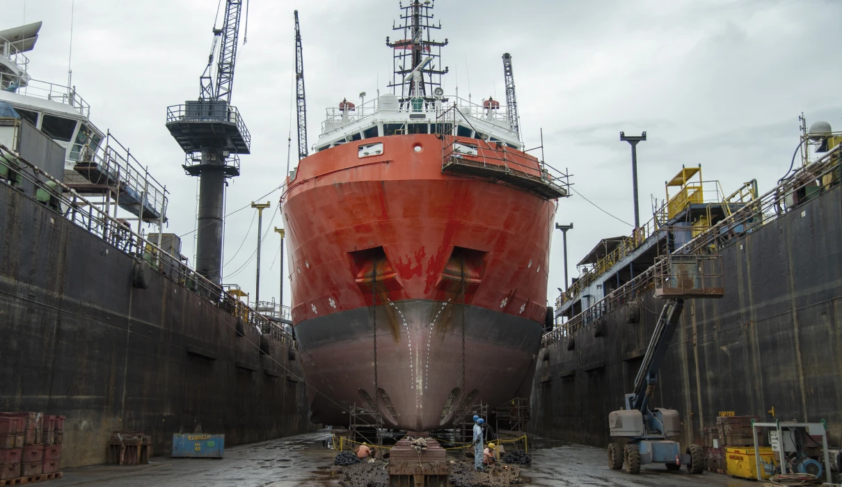 Docked ship with cranes nearby